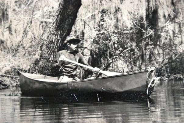 author paddling a canoe on the Black River in Eastern North Carolina in 1975