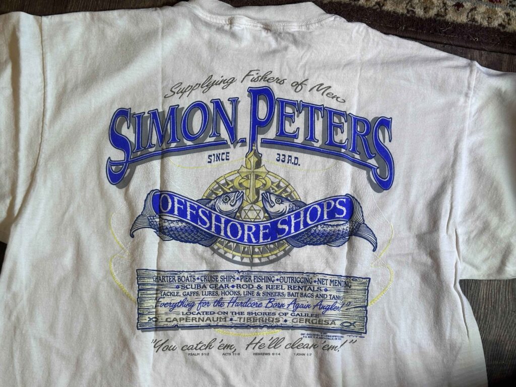 T-shirt advertising St. Peter's Offshore Shop along the Sea of Galilee