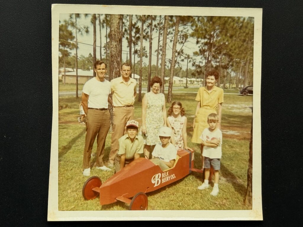 family and soap box derby car