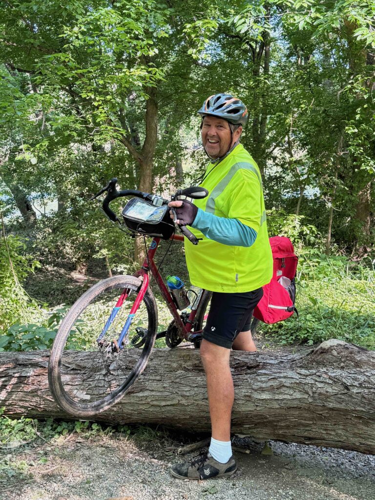 Author's brother pulling his bike over a tree